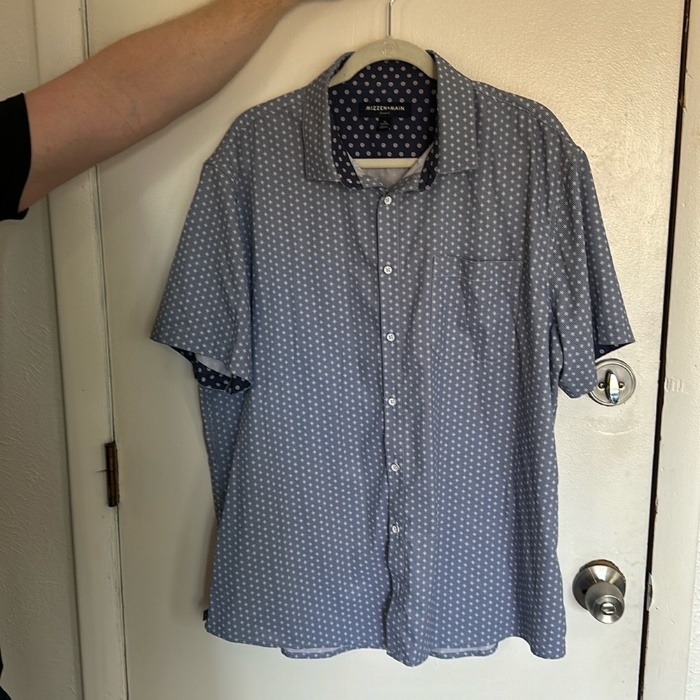 Blue short sleeve button up with detailed pattern.